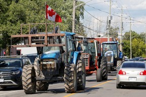 Des conducteurs de tracteurs manifestent lors d'un événement prévu avec le premier ministre Justin Trudeau qui a été annulé à Embrun, en Ontario, le 15 juillet 2022.