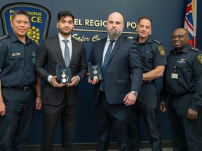 Peel Regional Police Const. Jason Beccario (third from right), shown receiving the Ontario Medal of Bravery in April, has been charged with assault.