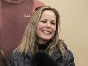 Tamara Lich, organizer for a protest convoy by truckers and supporters demanding an end to COVID-19 vaccine mandates, smiles during a news conference in Ottawa, Thursday, Feb. 3, 2022.