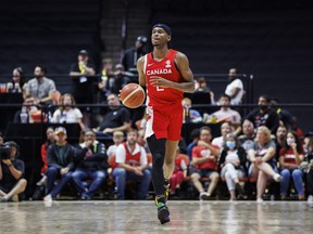 Canada's Shai Gilgeous-Alexander (2) dribbles up the court during second half FIBA international men's World Cup basketball qualifying action against Dominican Republic, in Hamilton, Ont., Friday, July 1, 2022. THE CANADIAN PRESS/Cole Burston