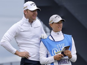 England's golfer Alex Wrigley gets supported by his wife Johanna Gustavsson during a practice round at the British Open golf championship in St Andrews, Scotland, Tuesday, July 12, 2022.
