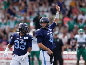 Toronto Argonauts' quarterback McLeod Bethel-Thompson, right, signals a call in front of teammate Andrew Harris looks to pass during the first half of CFL action against the Saskatchewan Roughriders at Acadia University in Wolfville, N.S., Saturday, July 16, 2022.