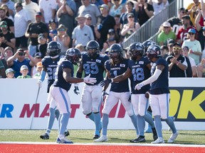 Toronto Argonauts' Wynton McManis, second from right, celebrates with teammates after running back a touchdown on an interception during the second half of CFL action against the Saskatchewan Roughriders at Acadia University in Wolfville, N.S., Saturday, July 16, 2022.