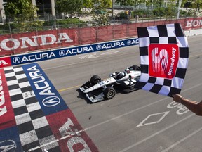 Simon Pagenaud of France crosses the finish line to win the 2019 Honda Indy Toronto, in Toronto, Sunday, July 14, 2019.
