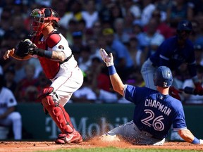 Toronto Blue Jays third baseman Matt Chapman slides safely into home scoring a run in front of Boston Red Sox catcher Christian Vazquez  during the third inning at Fenway Park yesterday.  USA TODAY SPORTS