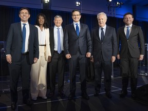 Candidates Patrick Brown, left, Leslyn Lewis, Scott Aitchison, Pierre Poilievre, Jean Charest and Roman Baber, pose for photos after the French-language Conservative Leadership debate Wednesday, May 25, 2022  in Laval, Que..THE CANADIAN PRESS/Ryan Remiorz