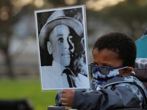 Four-year-old Senty Banutu-Gomez holds a photograph of Emmett Till, a 14-year-old Black boy who was lynched in 1955, at a vigil on the one year anniversary of the murder of George Floyd while in Minneapolis police custody, in Lynn, Massachusetts, May 25, 2021.