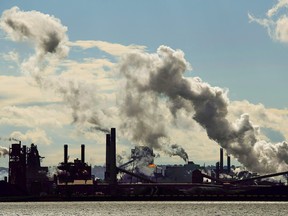 The steel mills in the Hamilton waterfront harbour are shown in Hamilton, Ont., on Tuesday, October 23, 2018. The Liberal federal government announced a new federal imposed carbon tax which will start in January. (CANADIAN PRESS/Nathan Denette)