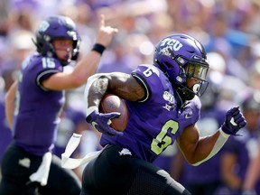 Darius Anderson of the TCU Horned Frogs scores a touchdown as quarterback Max Duggan #15 of the TCU Horned Frogs celebrates against the Southern Methodist Mustangs in the first quarter at Amon G. Carter Stadium on September 21, 2019 in Fort Worth, Texas.