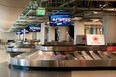 Air Canada signs are seen at the empty baggage claim area of Terminal 5 at Los Angeles International Airport (LAX) during the outbreak of the novel coronavirus, which causes COVID-19, April 16, 2020, in Los Angeles. (Photo by VALERIE MACON/AFP via Getty Images)