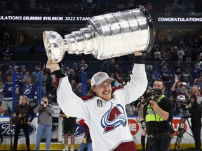 Nicolas Aube-Kubel #16 of the Colorado Avalanche carries the Stanley Cup following the series winning victory over the Tampa Bay Lightning in Game Six of the 2022 NHL Stanley Cup Final at Amalie Arena on June 26, 2022 in Tampa.