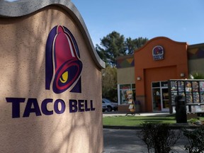 A sign is posted in front of a Taco Bell restaurant on February 22, 2018.