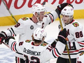 After the Blackhawks dealt Alex DeBrincat to Ottawa for a package of draft picks, it’s pretty clear that team is likely to tank this year. But don’t expect stars Jonathan Toews (top left) and Patrick Kane to stick around for that.