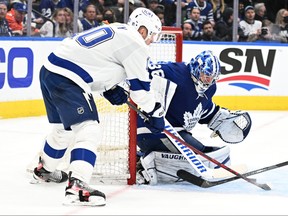 Maple Leafs goalie Jack Campbell (right) makes a save on a shot from Lightning forward Corey Perry during the playoffs. With so few free agent goalies remaining, teams may have to pay more money to sign Campbell.