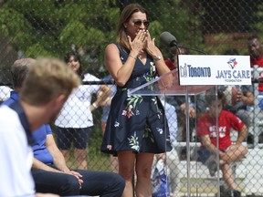 Brandy Halladay, widow of Toronto Blue Jays pitcher Roy "Doc" Halladay is overcome with emotion as she helps to open Roy Halladay Field in Scarborough.  It is TorontoÕs first accessible baseball diamond that is fully wheelchair accessible and for kids living with cognitive and/or physical disabilities   on Wednesday July 13, 2022. Jack Boland/Toronto Sun/Postmedia Network