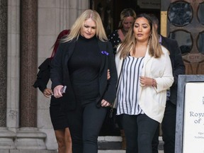 The mother of Archie Battersbee, Hollie Dance, left, leaves the Royal Courts of Justice in London, England, Monday, July 25, 2022.