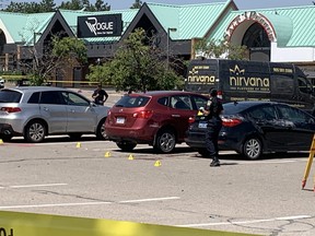 Peel Regional Police at the scene of a double stabbing early Monday, July 4, 2022 that left one man dead and a second injured outside a banquet hall in Mississauga.