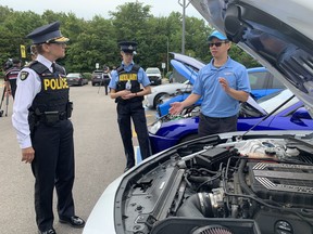 OPP Deputy Commissioner Rose DiMarco looks at a modified car during a news conference on Wednesday, July 27, 2022.