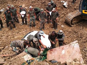 In this handout photo released by the Indian Army and taken Friday, July 1, 2022, security forces and disaster relief teams search for survivors and victims after a landslide in Noney district, some 50 km from Manipur's capital Imphal.