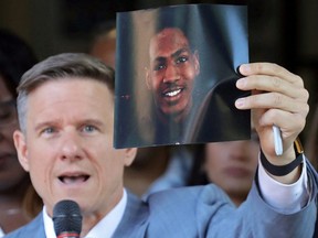 Attorney Bobby DiCello holds up a photograph of Jayland Walker, the man who was shot dead by Akron Police on June 25, as he speaks on behalf of the Walker family during a press conference at St.  Ashworth Temple in Akron, Ohio, Thursday, June 30, 2022.