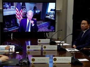 U.S. President Joe Biden appears on screen to meet virtually with a delegation from SK Group led by Chairman Chey Tae-won, to talk about SK's plans for $22 billion in new investments in the U.S. in semiconductors, green energy and bioscience projects, from the Roosevelt Room at the White House in Washington, D.C., Tuesday, July 26, 2022.