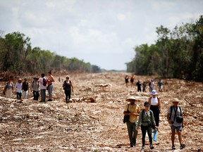 Activists and locals march as they protest at one of the construction sections of the Mayan train due to the environmental impact and the destruction of the jungle caused by the project, in Playa del Carmen, Mexico April 23, 2022.