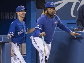 Vladimir Guerrero Jr. of the Toronto Blue Jays, right, is seen with first base coach Mark Budzinski in Toronto on Saturday, Sept. 28, 2019. (Fred Thornhill/The Canadian Press)