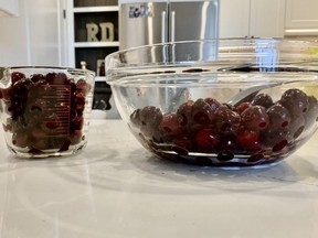 Measuring fresh cherries to make cherry jam.