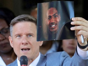 Attorney Bobby DiCello holds up a photograph of Jayland Walker, the man who was shot dead by Akron Police on June 27, as he speaks on behalf of the Walker family during a press conference at St. Ashworth Temple in Akron, Ohio, U.S. June 30, 2022.