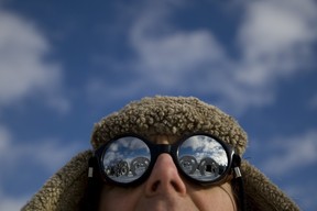 Peter Camani, sculptor, poses for a portrait at his home near Burk’s Falls Ontario. The reflections in his glasses are large monolith-like sculptures in the shape of giant screaming heads that he has scattered throughout the property of his unique home. (Tyler Anderson/Postmedia)
