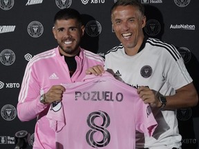 Inter Miami CF MLS soccer team's newest player, Alejandro Pozuelo, left, poses with head coach Phil Neville during a news conference to introduce Pozuelo, Friday, in Fort Lauderdale, Fla. Wilfredo Lee/The Associated Press