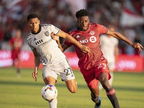 San Jose Earthquakes defender Marcos Lopez (27) battles for the ball with Toronto FC forward Deandre Kerr during the first half at BMO Field on Saturday night.