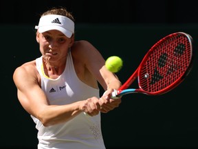 Elena Rybakina plays a backhand against Ons Jabeur during the Wimbledon final on July 9, 2022 in London, England.