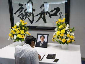 A man pays tribute to slain former Japanese prime minister Shinzo Abe at the Consulate General of Japan in Medan on July 11, 2022.