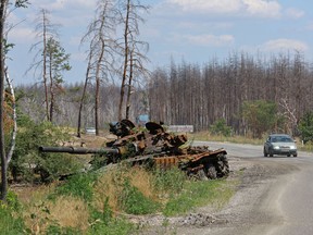 A view shows a destroyed tank alongside the road outside the city of Sievierodonetsk in the Luhansk Region, Ukraine July 1, 2022.