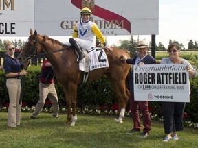 Trainer Roger L. Attfield (second from right) captured his 2,000th career win after Lady Shakespeare, in a dead heat, captures the $175,000 Nassau Stakes at Woodbine Racetrack on July 2, 2022.