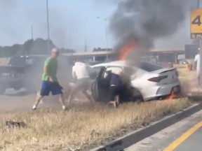 A group of Good Samaritan motorists rescue a man from a burning car on a section of the QEW in Mississauga at Cawthra Road July 4, 2022.