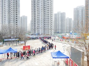 In this file photo, people line up in the Chinese city of Tianjin for nucleic acid testing for COVID-19 in January after local cases of the Omicron variant were detected.
