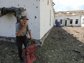 A local resident reacts near a school building damaged by a Russian missile strike, as Russia's attack on Ukraine continues, in Mykolaiv, Ukraine July 28, 2022.