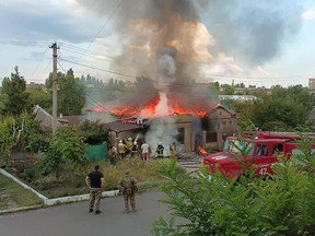 A residential house burns after a Russian military strike in the city of Bakhmut, Ukraine, July 28, 2022.