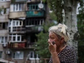 A local resident Zinaida Klimova, 85, reacts near her residential building damaged by a Russian military strike, amid Russia's invasion on Ukraine, in Kramatorsk, in Donetsk region, Ukraine July 19, 2022.