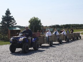A tractor pulls wagons to and from the apple orchards at Le Verger a Ti-Paul in Saint-Elzear, Que. (RUTH DEMIRDJIAN DUENCH/Toronto Sun)