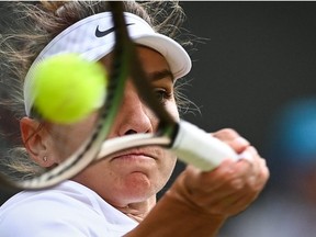 Romania's Simona Halep returns the ball to Spain's Paula Badosa during their round of 16 women's singles tennis match on the eighth day of the 2022 Wimbledon Championships at The All England Tennis Club in Wimbledon, southwest London, on July 4, 2022.