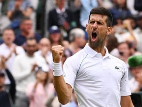 Serbia's Novak Djokovic celebrates winning against Italy's Jannik Sinner during their men's singles quarter final tennis match on the ninth day of the 2022 Wimbledon Championships at The All England Tennis Club in Wimbledon, southwest London, on July 5, 2022.
