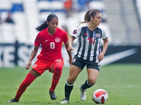 Canada's Jayde Riviere (L) vies for the ball with Costa Rica's Priscila Chinchilla (R) during their 2022 Concacaf Women's Championship football match, at the BBVA Bancomer stadium in Monterrey, Nuevo Leon State, Mexico on July 11, 2022. (Photo by  / AFP)