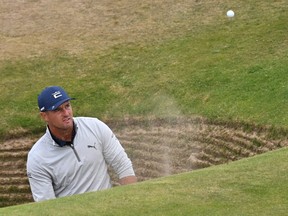 US golfer Bryson DeChambeau plays from the road hole bunker during a practice round for The 150th British Open Golf Championship on The Old Course at St Andrews in Scotland on July 13, 2022.