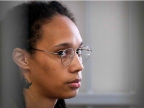 WNBA superstar Brittney Griner sits inside a defendants' cage before a hearing at the Khimki Court, outside Moscow on July 27, 2022.