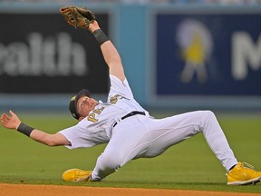 National League second baseman Jake Cronenworth (9) of the San Diego Padres stumbles backwards after missing a ball during the eighth inning of the 2022 MLB All Star Game at Dodger Stadium.