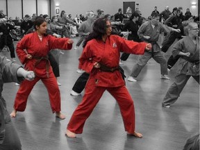 Jasmine Ready, 15, and mother Anne-Marie Ready, in red, during their grading to receive a black belt from Douvris karate school in Ottawa. Mother and daughter were killed in a knife attack at their Alta Vista home on June 27, 2022. A neighbour, 21-year-old Joshua Graves, was shot dead by police as he was stabbing Catherine Ready, 19, who was taken to hospital with injuries.