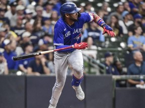 Jun 25, 2022; Milwaukee, Wisconsin, USA;  Toronto Blue Jays left fielder Lourdes Gurriel Jr. (13) hits a double in the fifth inning during game against the Milwaukee Brewers at American Family Field.